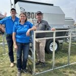 Gerard Roney, right, of Advantage Feeders, pictured here with Marlin and Myrna Huber of Huber Ag Equipment, travelled from Australia to Ag in Motion 2025 to discuss creep feeding options for calves and lambs. Photo: Piper Whelan
