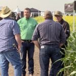 Spencer Harris , in the green shirt, speaks with attendees at the Nutrien Ag Solutions crop plots at Ag in Motion on July 16. Photo: Greg Berg