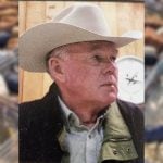 photo of Dennis Johnston wearing a white cowboy hat
