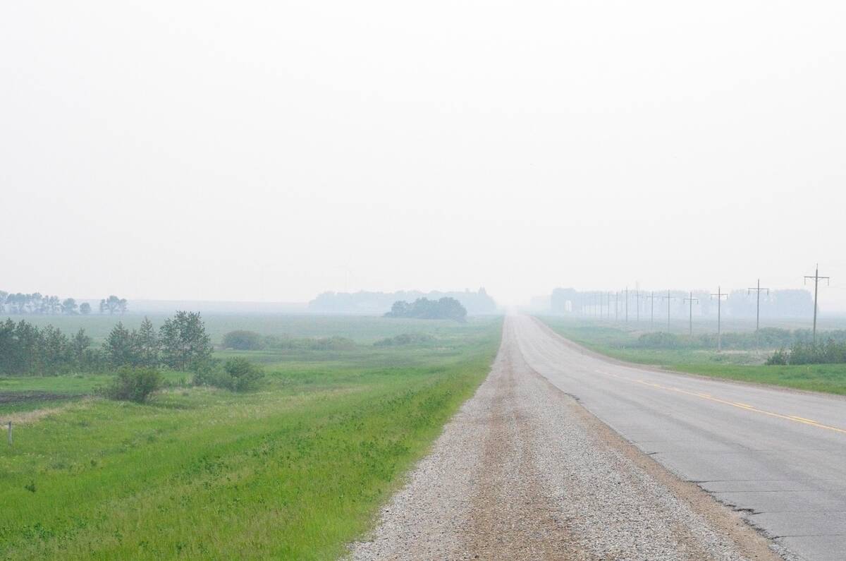 Smoke from wildfires blankets farm fields in central Manitoba June 9, 2025.