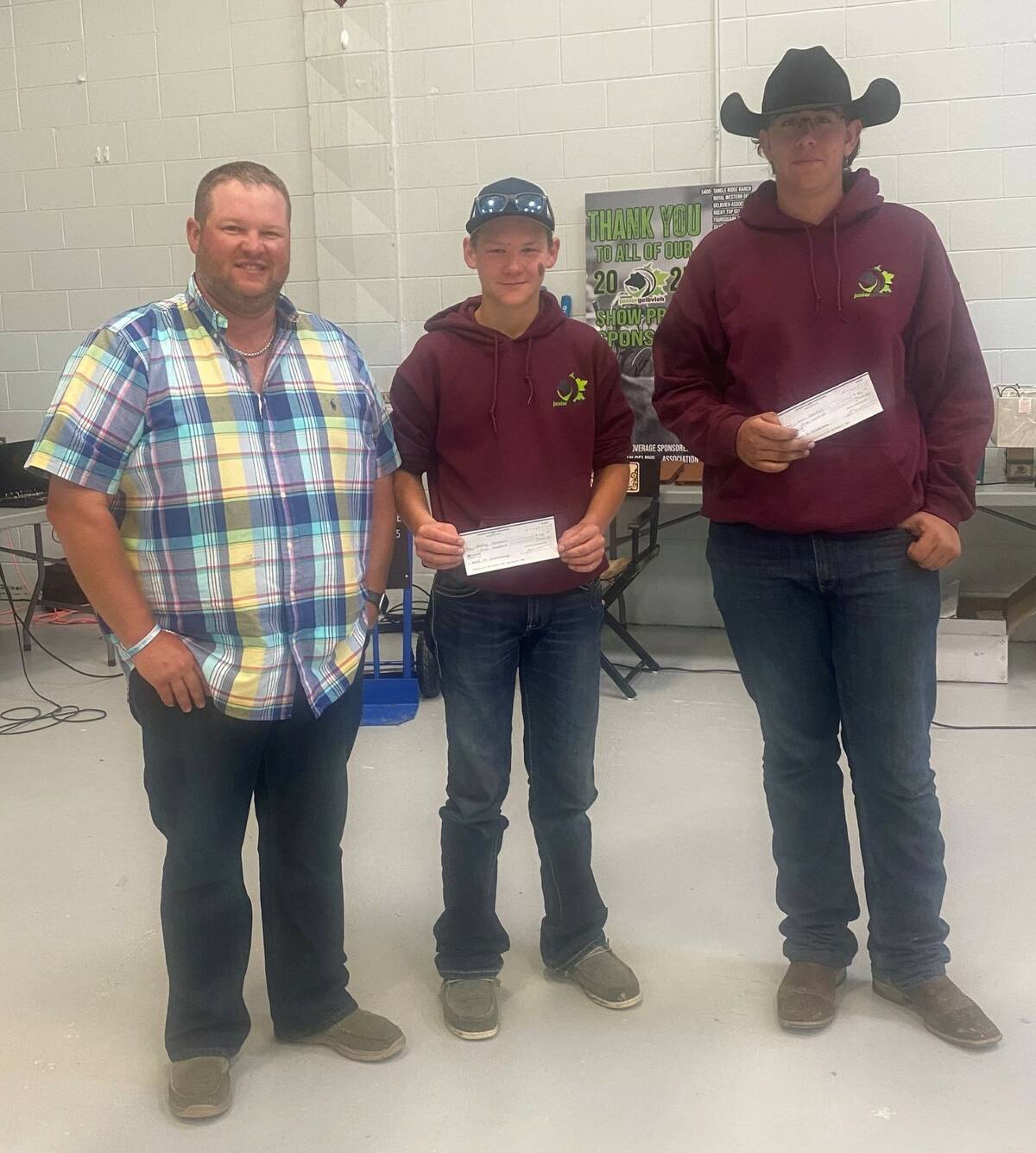 Duncan Pearson presents Keston Hollman (left, on behalf of Wacey) and Levi Hamilton (right) with their scholarship cheques. Photo: Supplied
