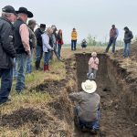 Yamily Zavala, PhD, talks soil health while in a soil pit near Paradise Hill, Sask. Zavala was the featured speaker during the Saskatchewan-Alberta Grazing Club Field Day on August 8, 2025.
