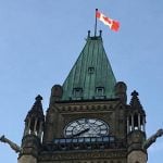 A Canadian flag flies at the top of one of the Parliament buildings in Ottawa. Photo: File
