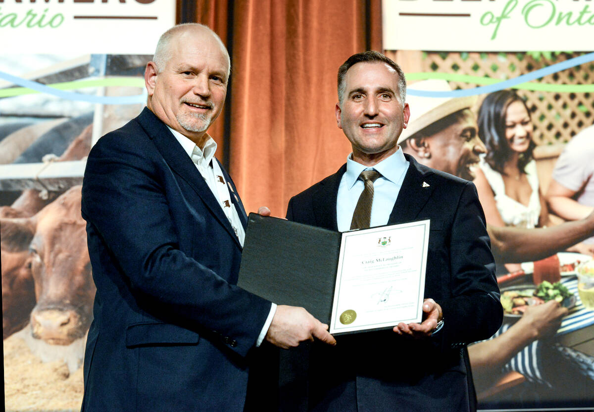 Trevor Jones, Ontario Minister of Agriculture, Food and Agri-business, right, presents Craig McLaughlin, outgoing president of Beef Farmers of Ontario,  left, with a certificate recognizing his contributions to the sector at BFO's annual general meeting gala in Toronto on Feb. 18, 2026. Photo: Diana Martin

