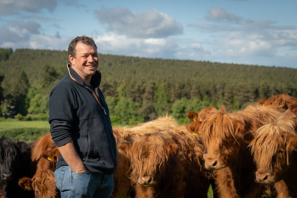 Scottish beef producer Jock Gibson poses with his cattle in a field at his farm in Moray, Scotland. Photo: Jock Gibson